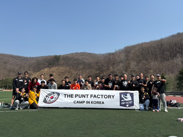 Camp group with The Punt Factory banner in South Korea