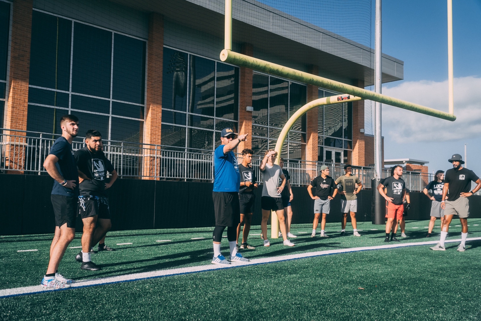 Aaron Perez coaching camp athletes on the field