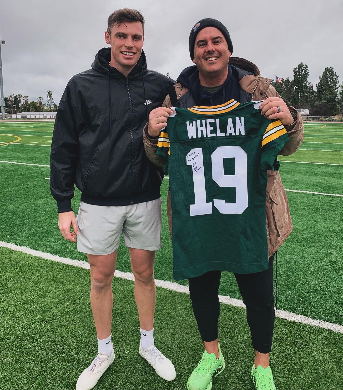 Aaron Perez with NFL punter Daniel Whelan — Green Bay Packers jersey